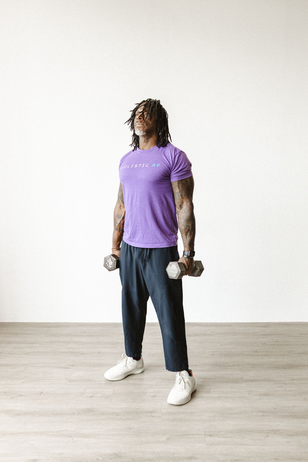 Coach Jamal holding dumbbells