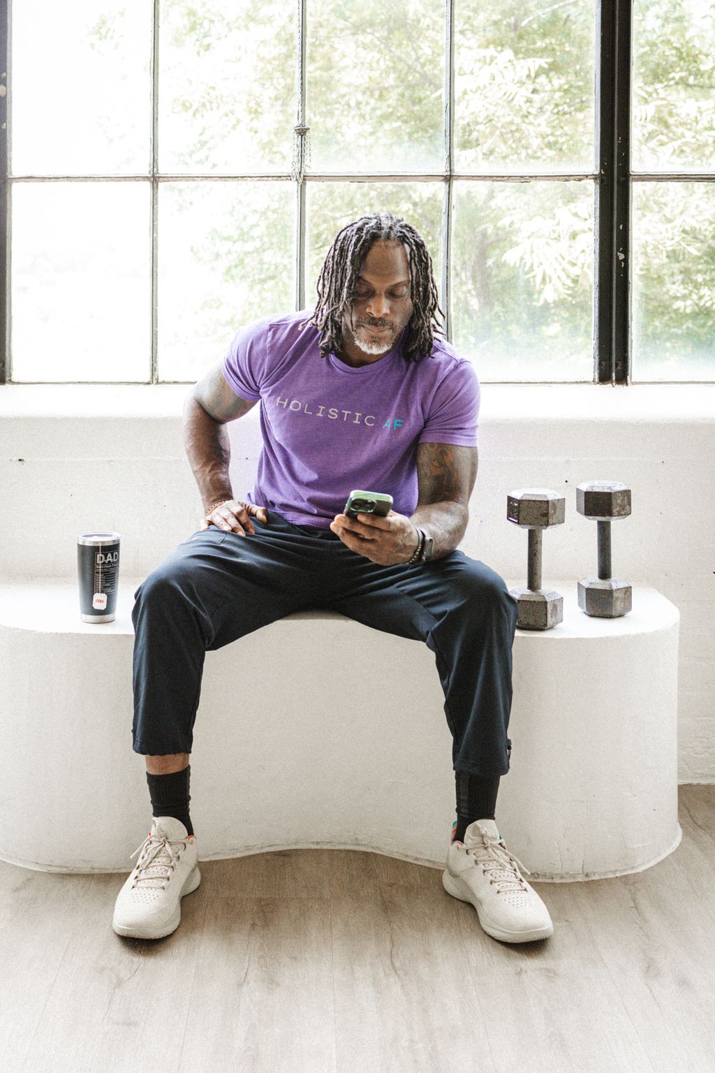 Coach Jamal checking the app on his phone