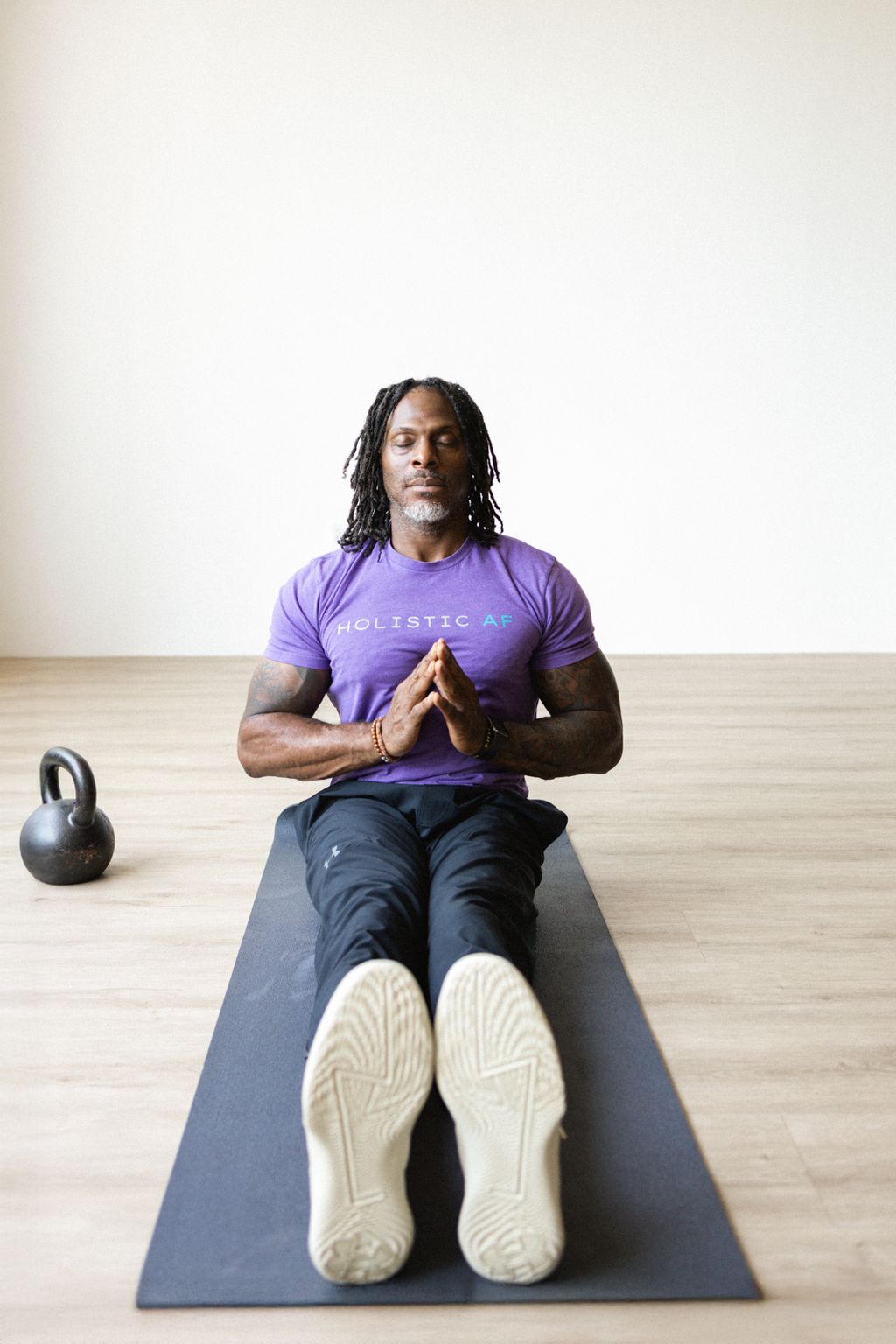 Coach Jamal on a mat with a kettlebell