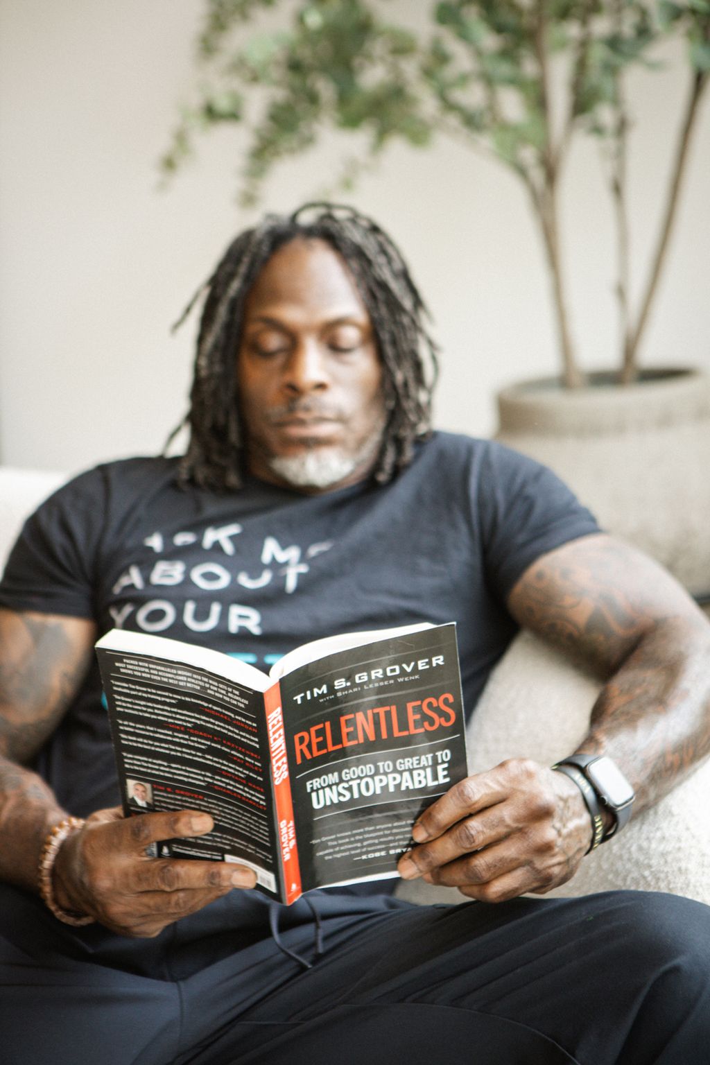 Coach Jamal reading in his armchair