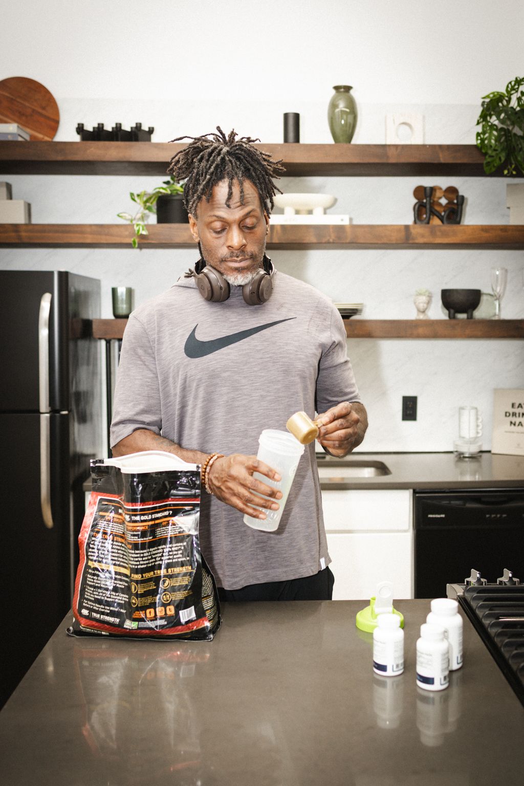 Coach Jamal in his kitchen with a shaker
