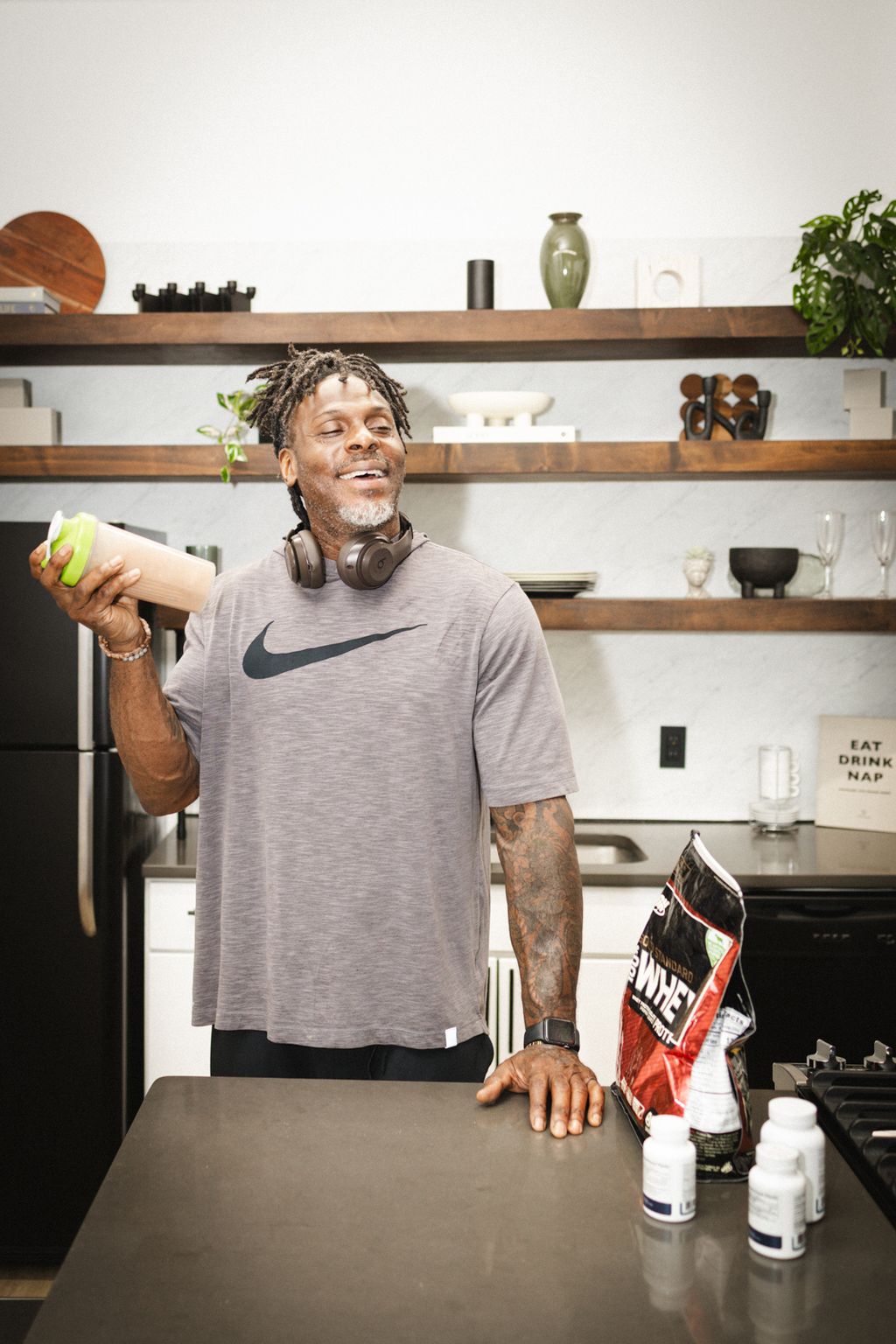 Coach Jamal in his kitchen with a protein shaker