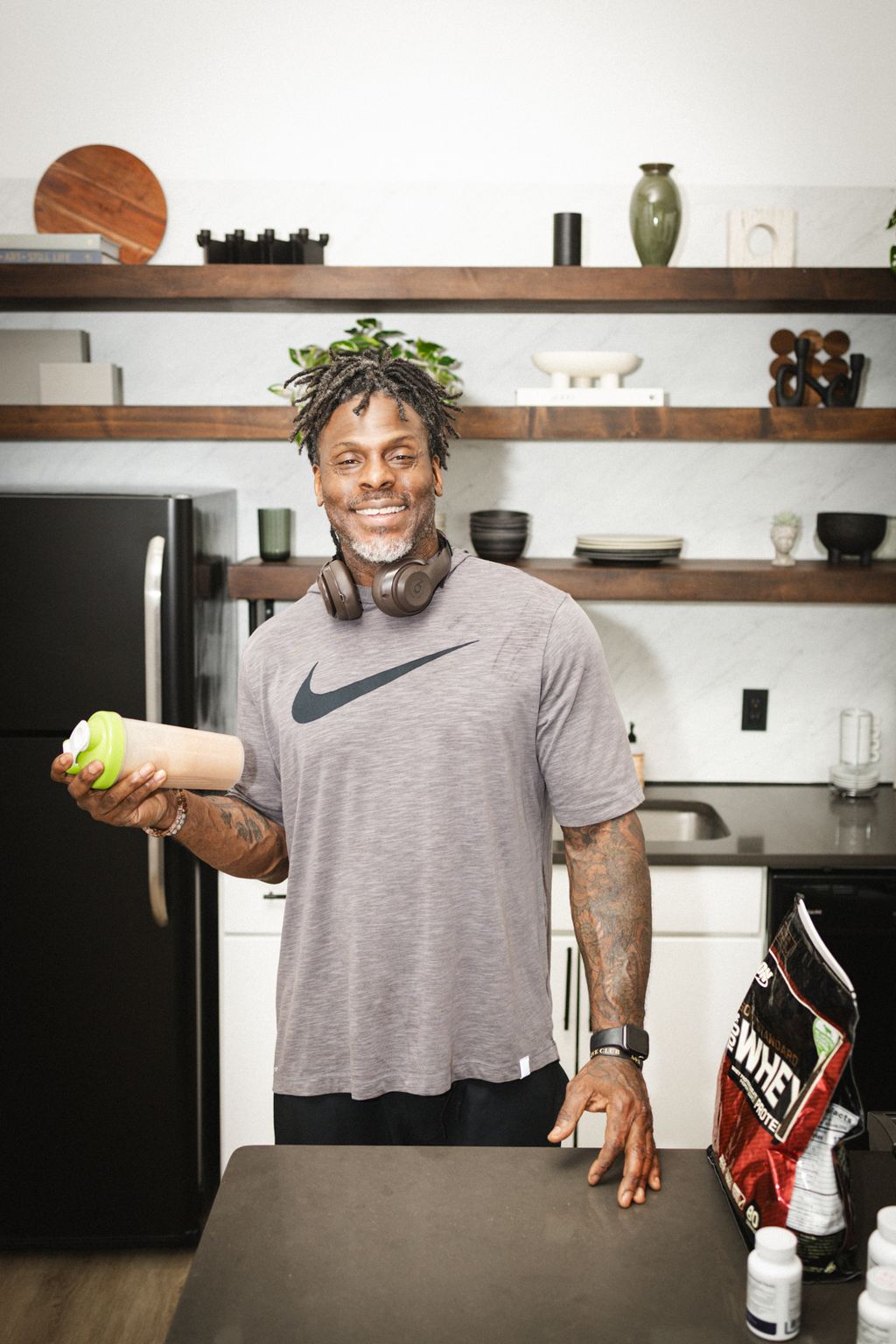 Coach Jamal with a shaker in his kitchen