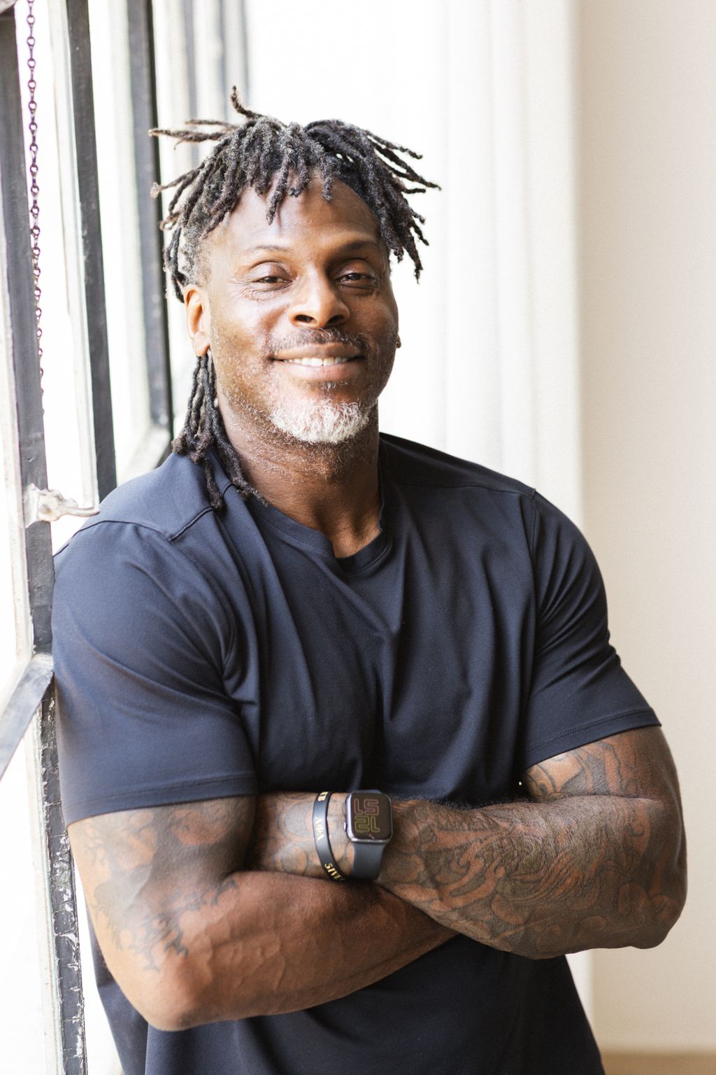 Coach Jamal Powers, arms crossed